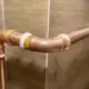 A copper gas pipe with white tape